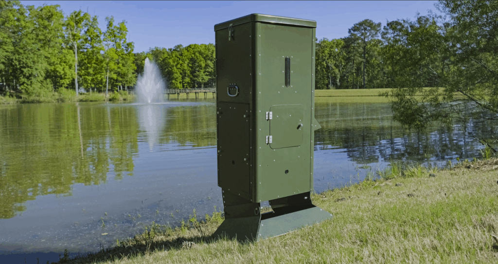 solar powered fish feeder by lake with fountain