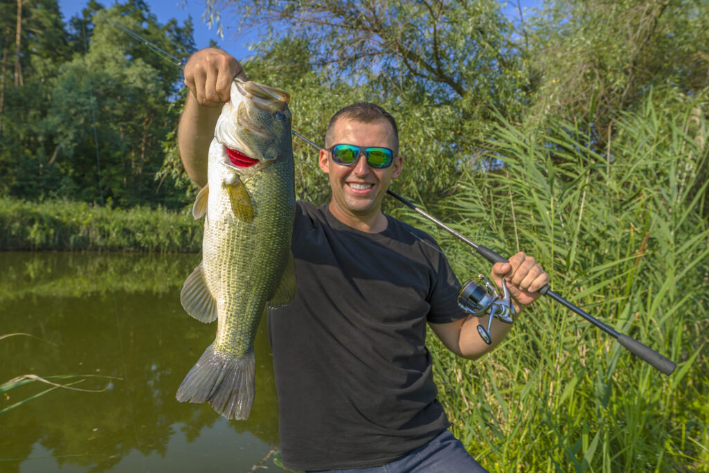 angler holding largemouth bass